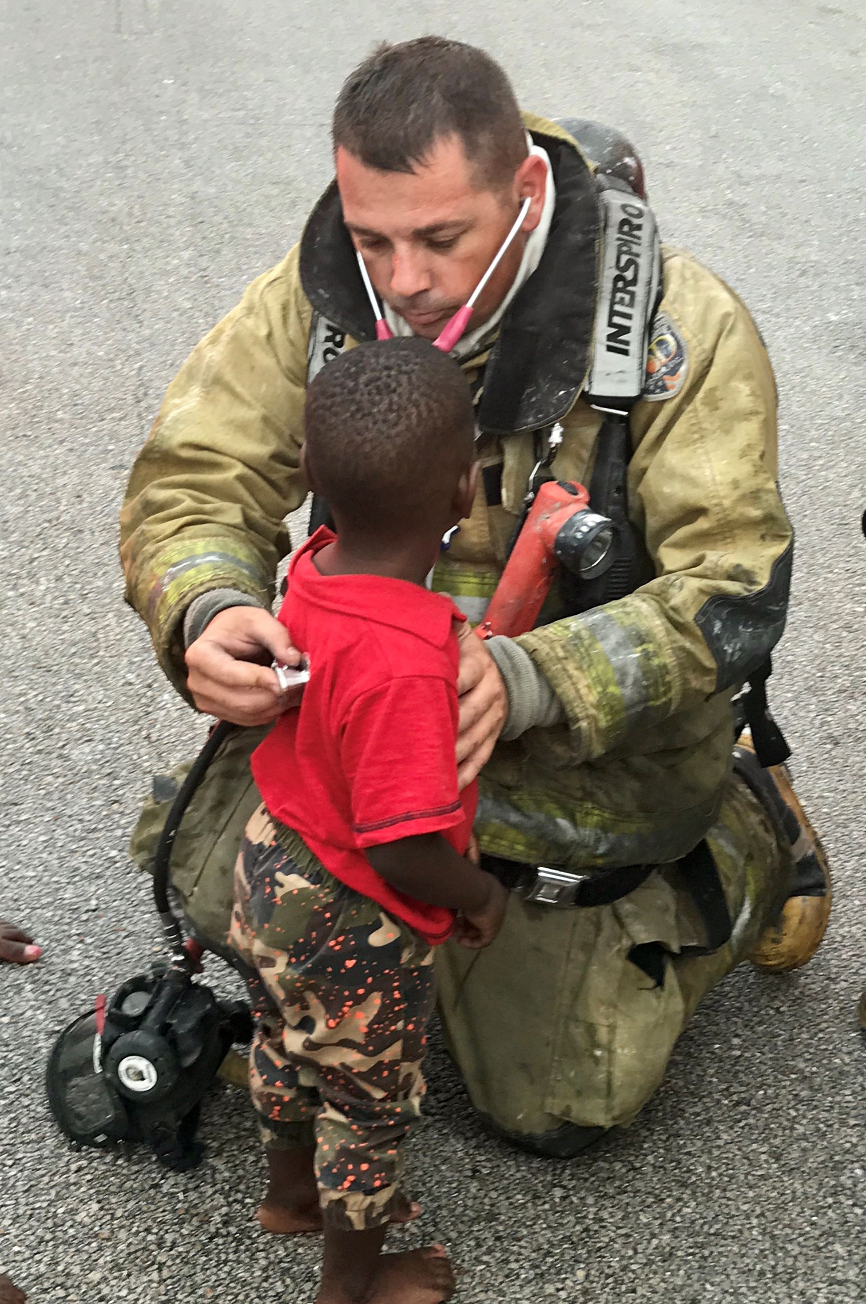 Firefighter helps a small child