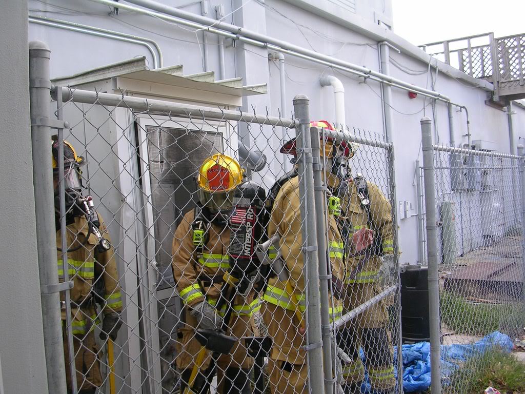Firefighters behind fence